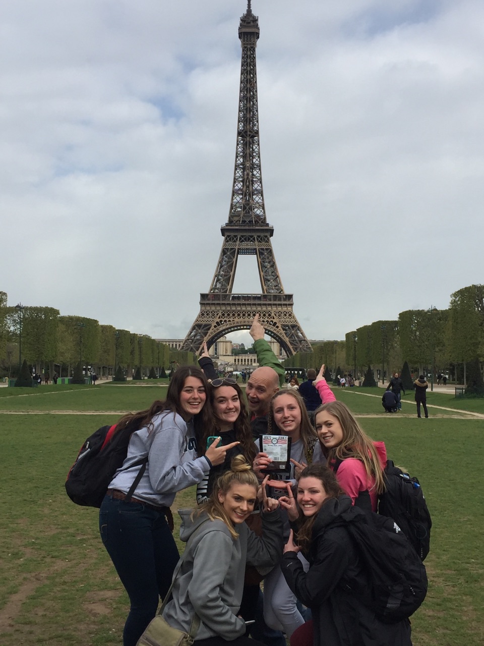 Joes granddaughter Mckenna Berry and her class on a school trip to Paris in front of the Eifle Tower with Joe's Jerky